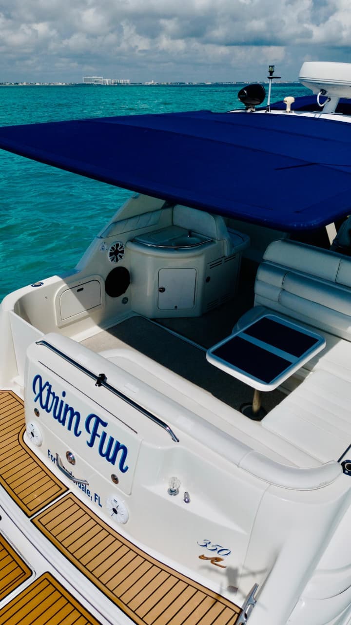 Guests celebrating with drinks and music on a private yacht deck
